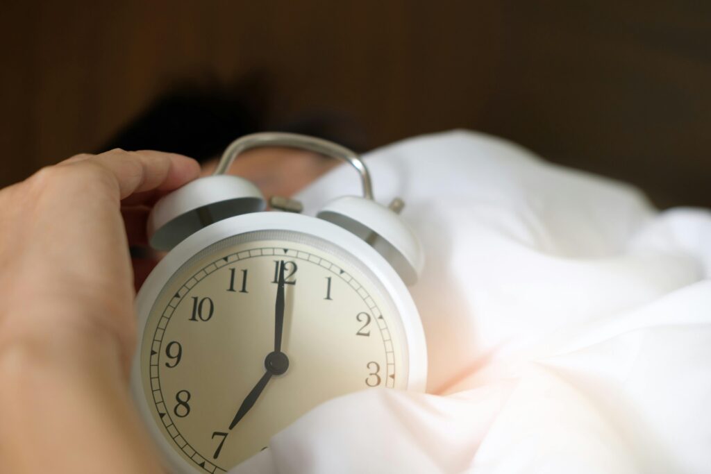 Woman holding an alarm clock
